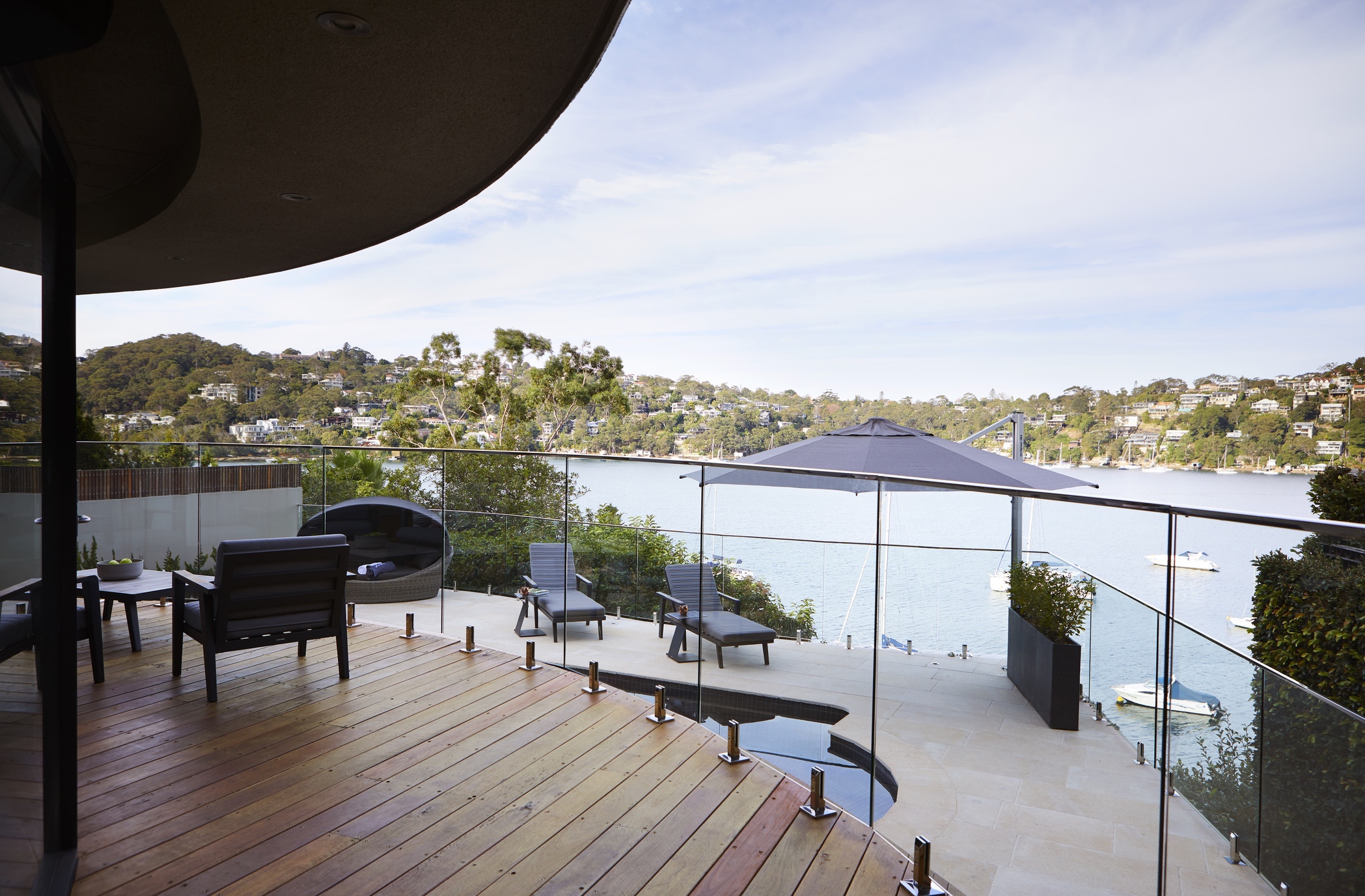 Frameless glass balustrade on a timber deck looking over Middle Harbour at a Castlecrag residence