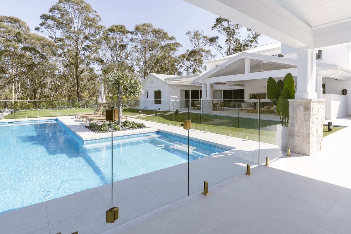 Frameless glass pool fence and pool seen from the covered terrace at an Annangrove residence