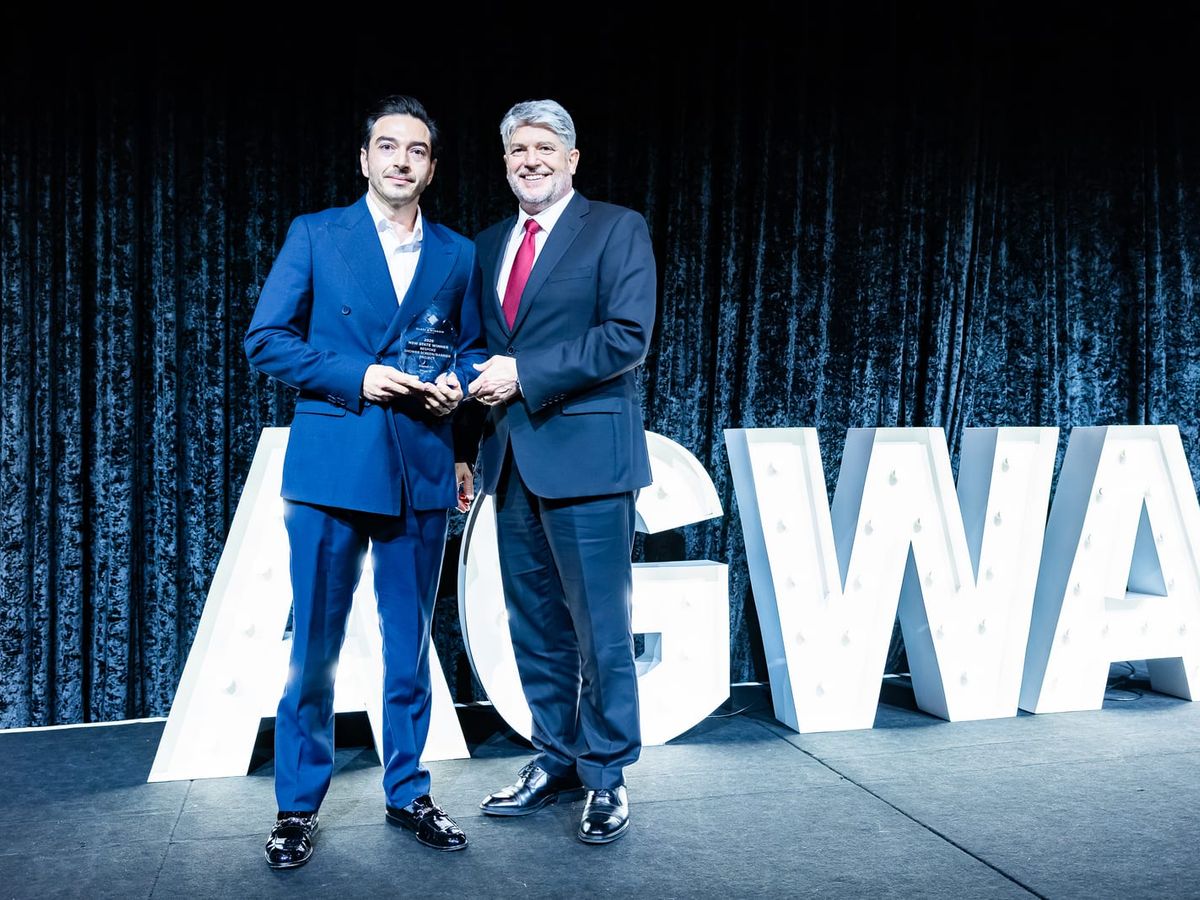 Daniel Chamoun of Glazed Co. holding the 2026 AGWA Design Awards NSW State Winner trophy with the AGWA presenter.