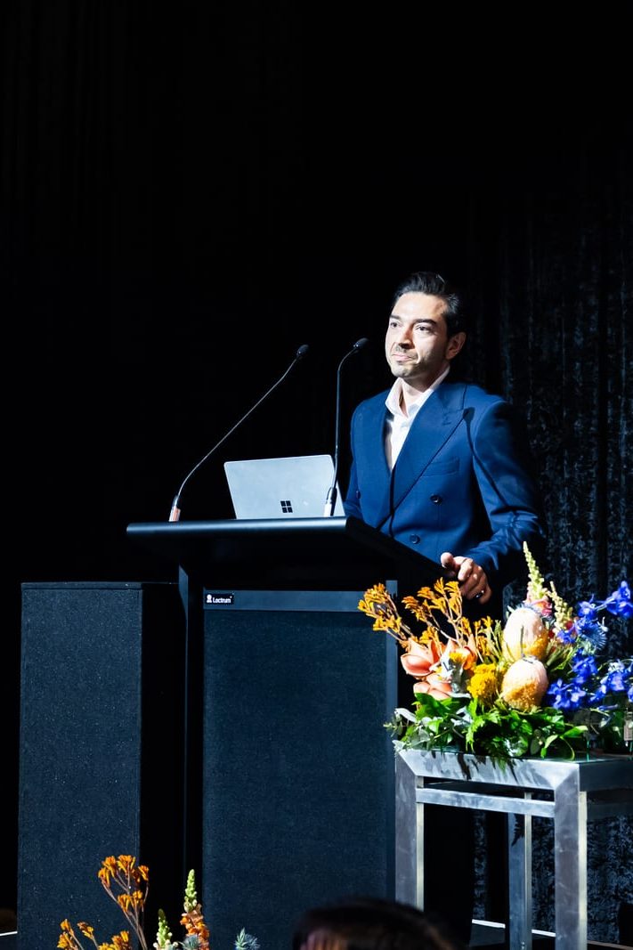 Daniel Chamoun of Glazed Co. speaking at the lectern at the 2026 AGWA Design Awards.